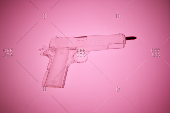 X-ray of a gun on pink background