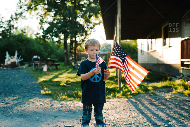 Boy waving American flags