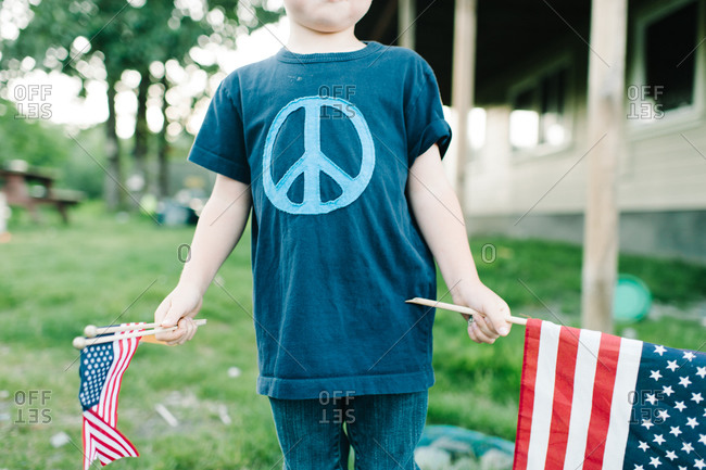 Boy holding American flags