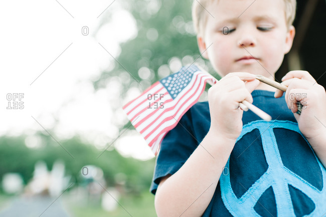 Close up of boy holding American flags