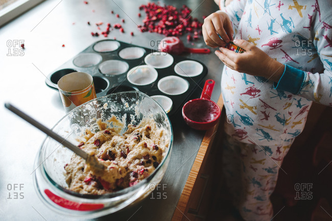 Boy making cranberry muffins