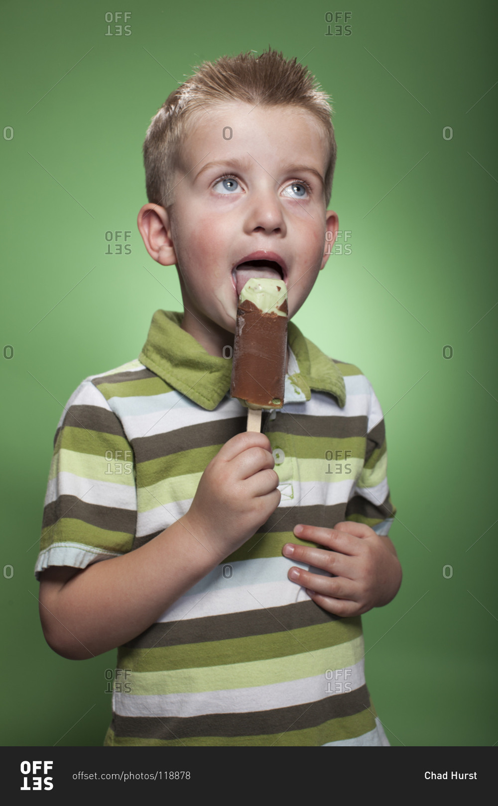 Redhead boy eating pistachio ice cream bar