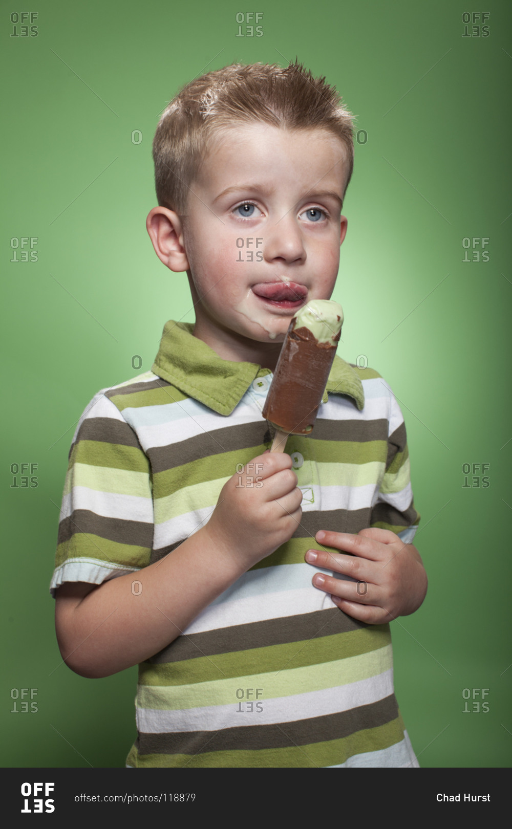 Redhead boy eating pistachio ice cream bar
