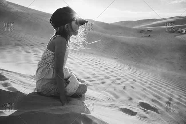 Girl kneeling in a desert