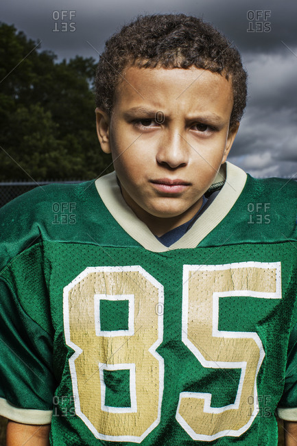 Ethnic kid in American football player costume · Free Stock Photo