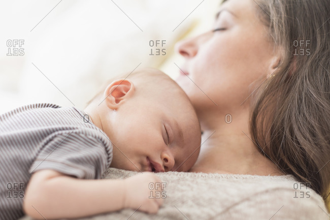 Mother with baby boy taking nap together