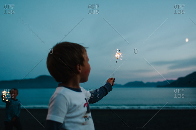 Boys playing with sparklers - Offset