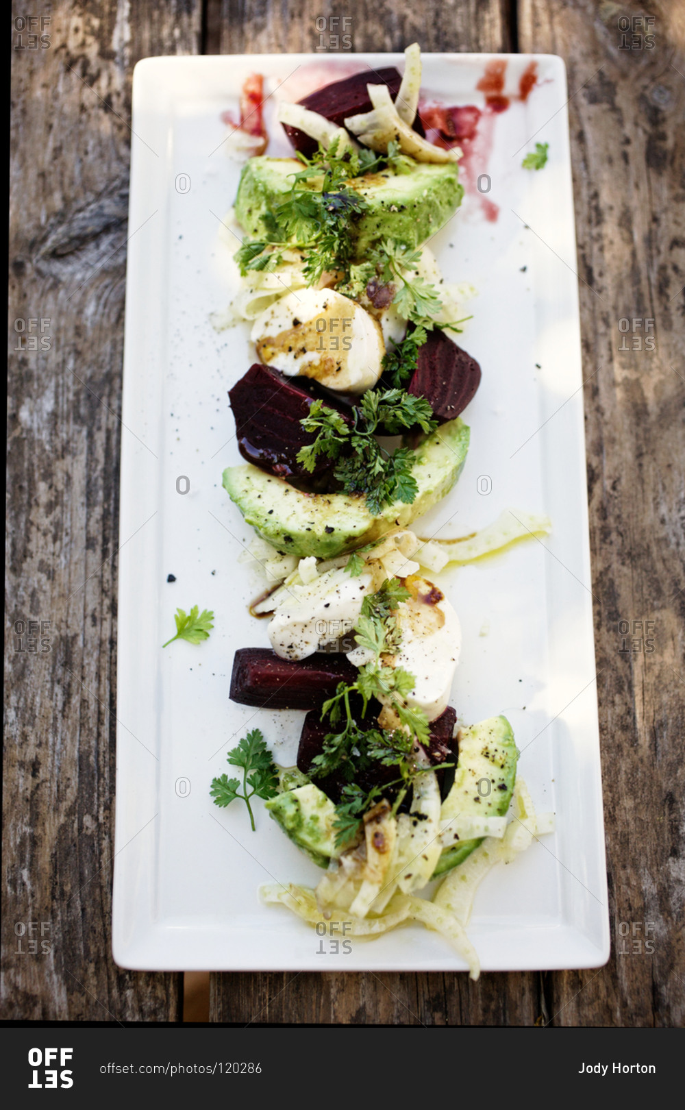 Beet and avocado salad with mozzarella and fennel stock photo OFFSET