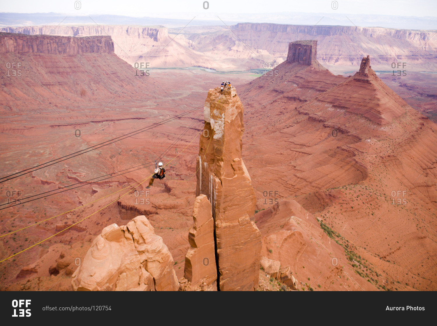 Adventure racer on a Tyrolean Traverse high above the desert in a race in Moab Utah.