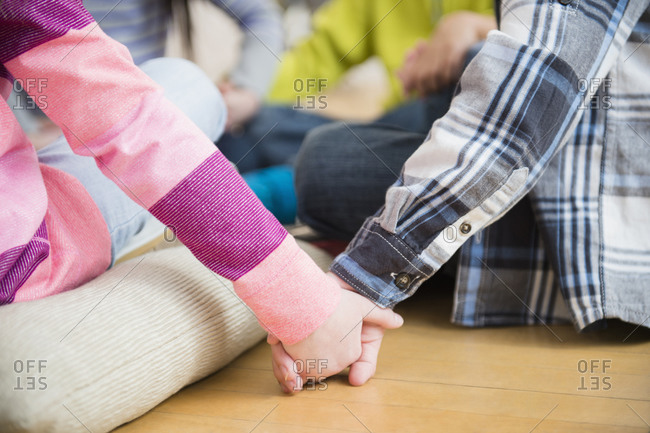 Close up of children holding hands