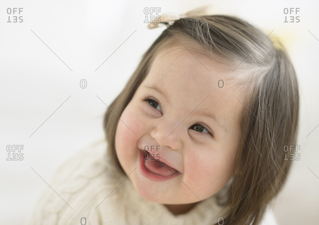 Hispanic toddler with Down syndrome laughing