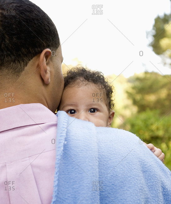 Father holding baby on shoulder