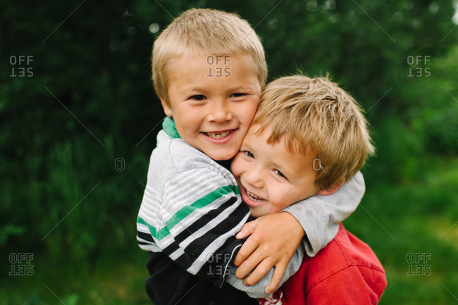 Older brother holding tight his younger brother