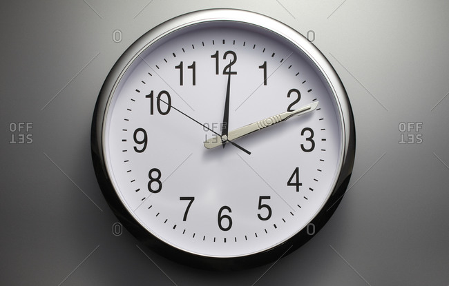 Wall clock with a scalpel as one of the hands stock photo - OFFSET