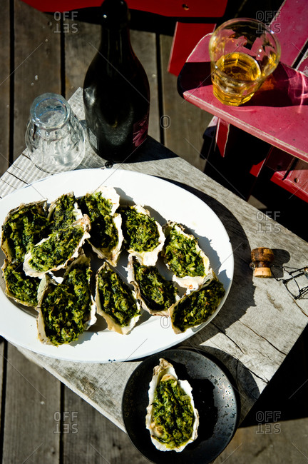 Prepared oysters rockefeller on oval-shape plate