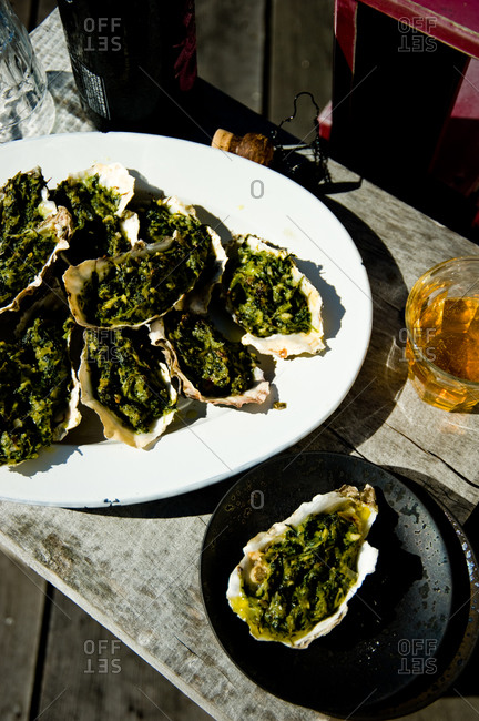 Close up of oysters rockefeller on oval-shape plate