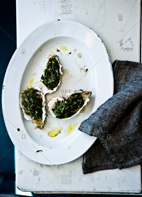Three oysters rockefeller on plate