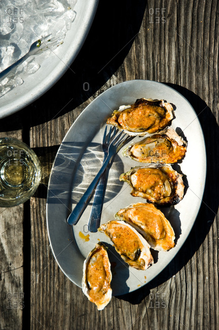Oysters with creamy sauce on a platter