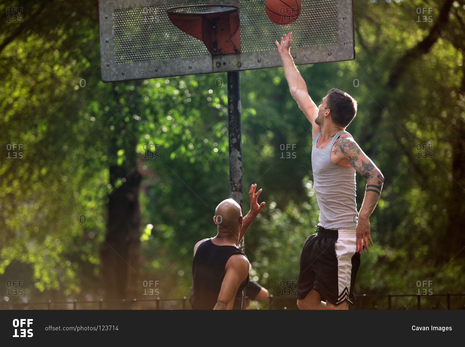 Man jumping to slam dunk a basketball
