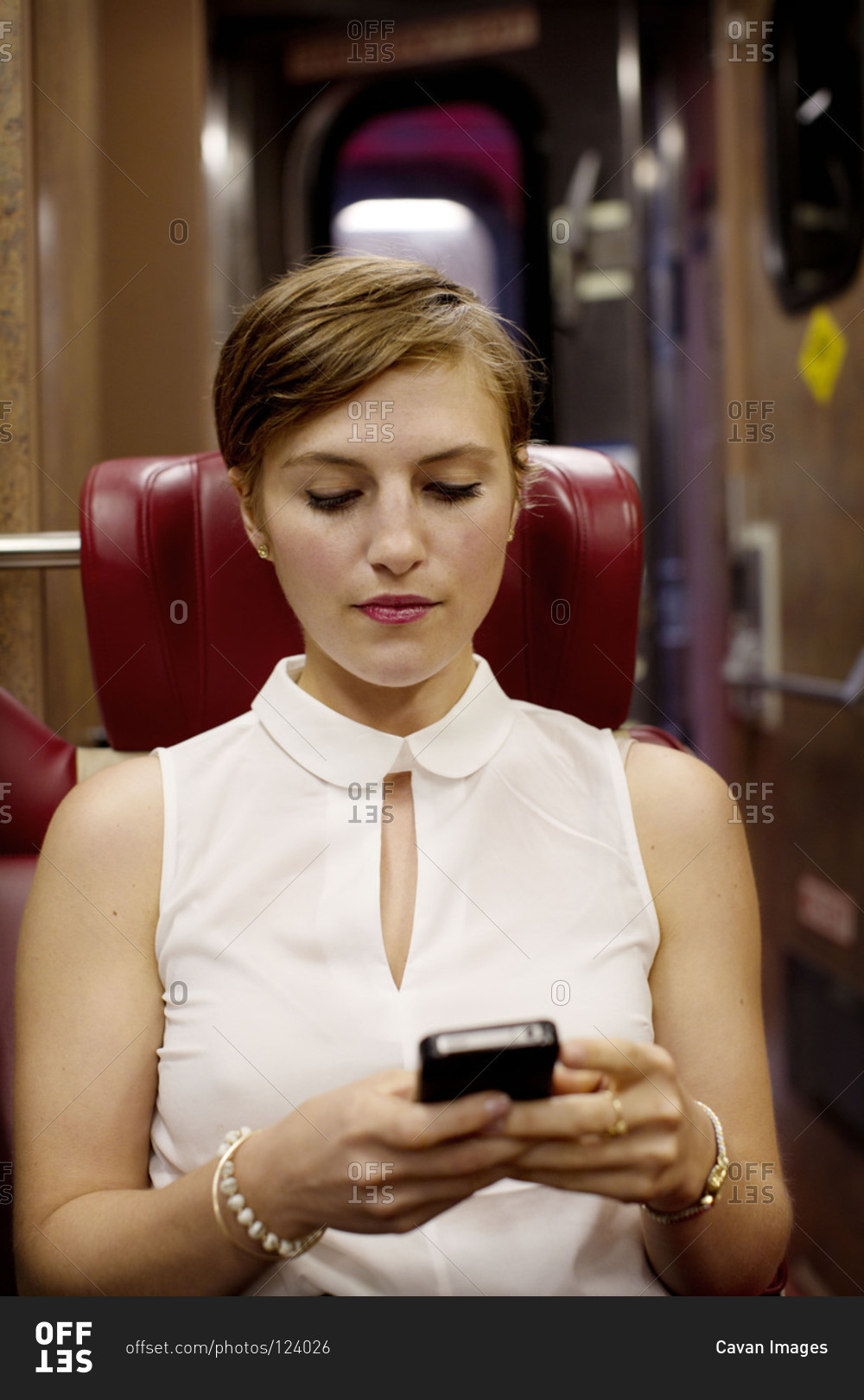 Young woman traveling by train and checking her emails