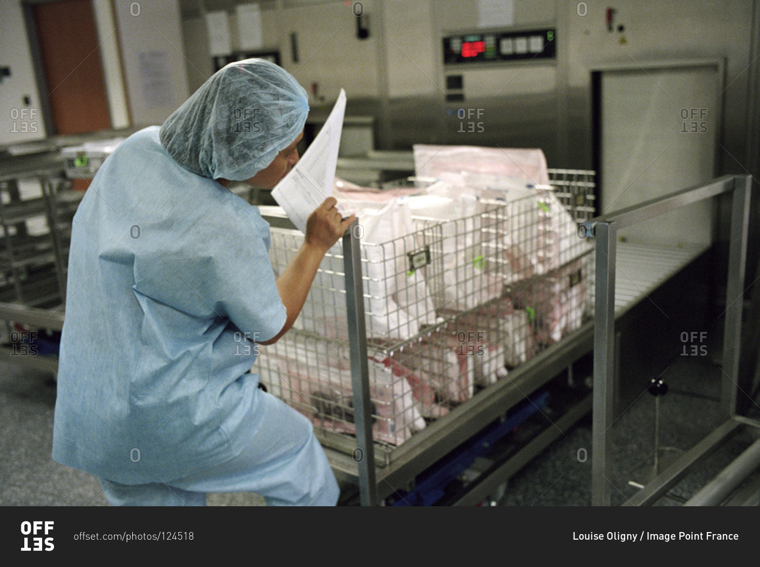 Medical worker sterilizing surgical equipment