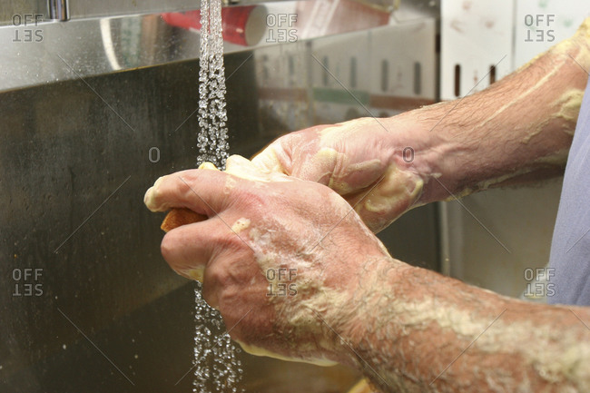 Surgeon washing his hands with surgical soap