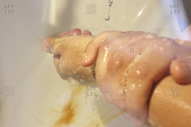 Close up of surgeon washing his hands with surgical soap