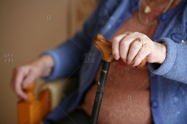 Close up of an elderly woman holding a cane