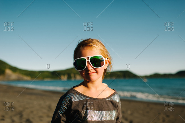 Girl wearing oversized sunglasses on the beach