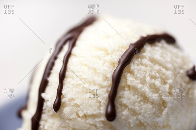 A scoop of ice cream with chocolate sauce