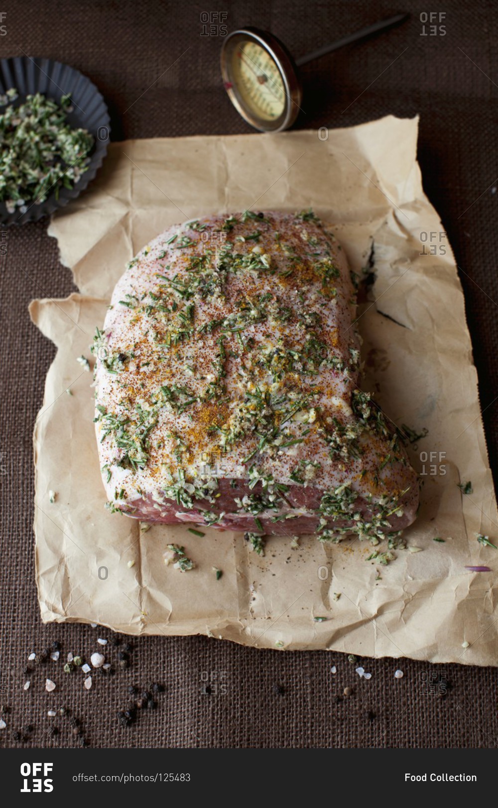 Uncooked lamb roast seasoned with herbs