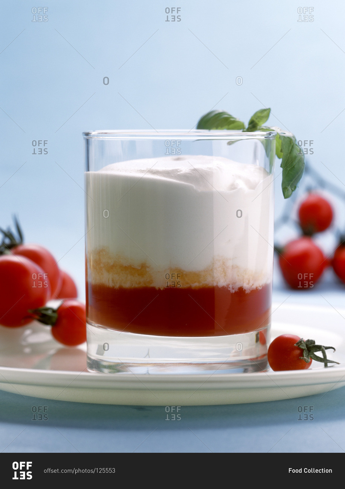 Tomato puree with head of white foam in glass