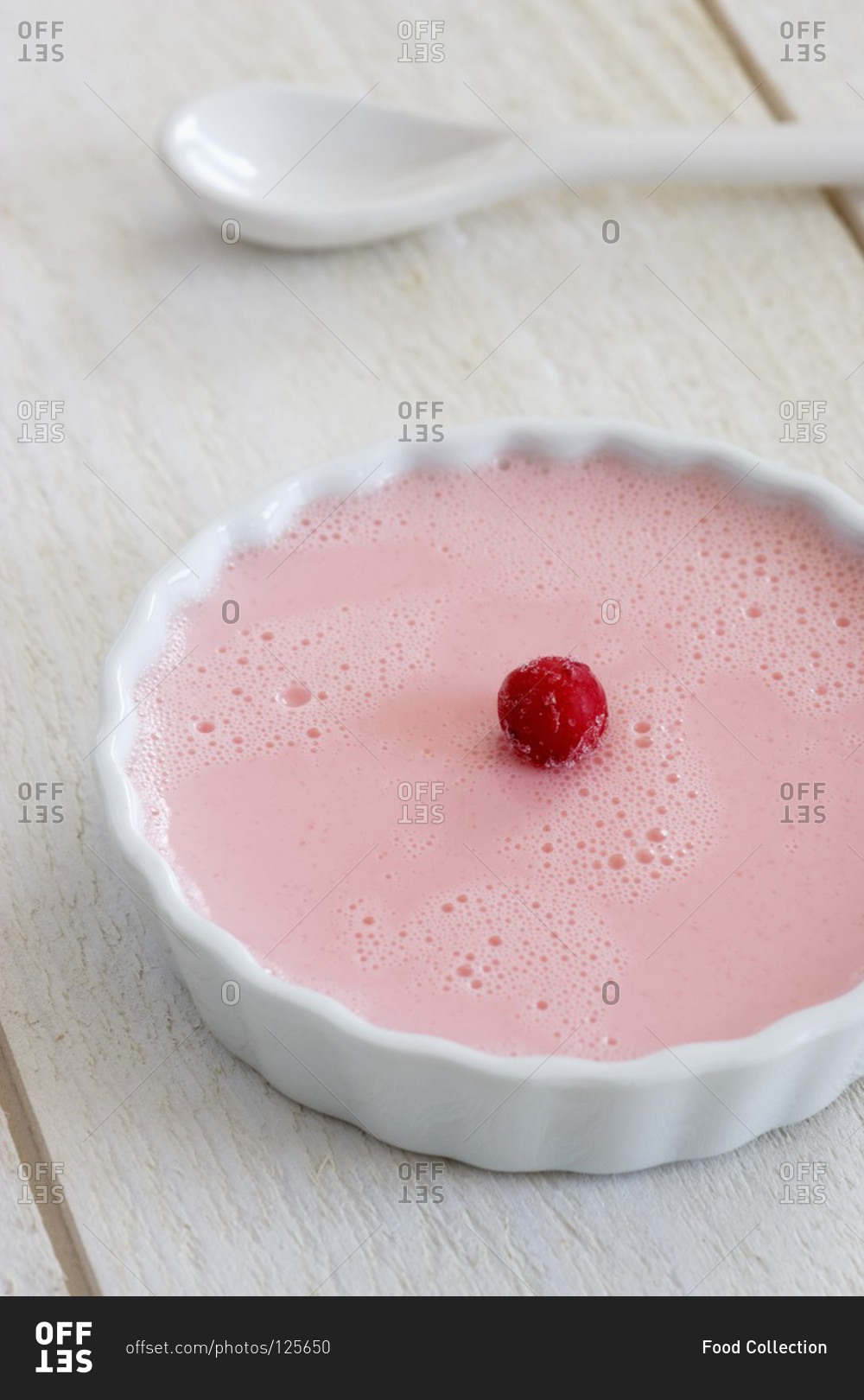 A raspberry flan in a round dish
