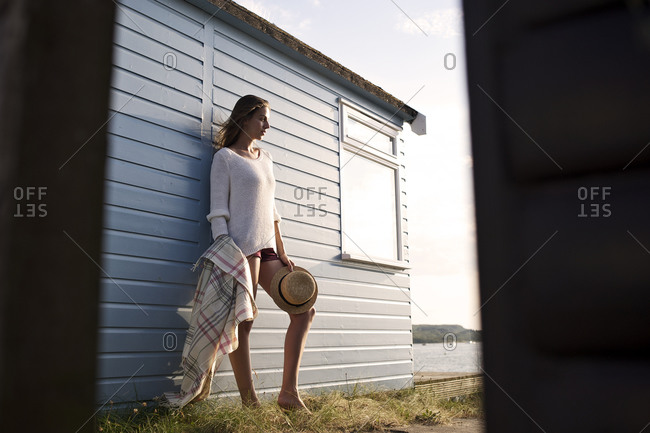 Young woman posing by a beach house