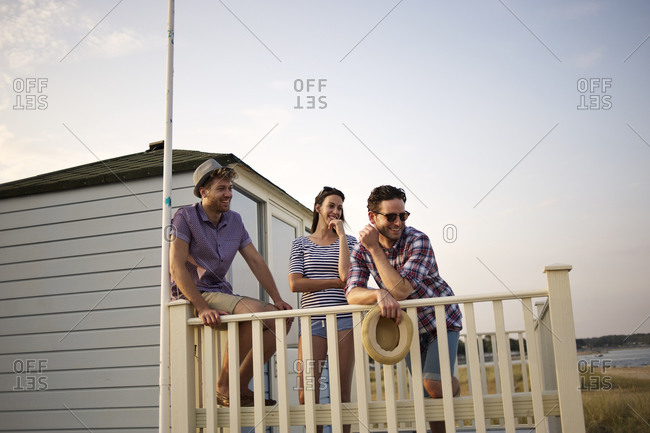 Friends laughing on a balcony
