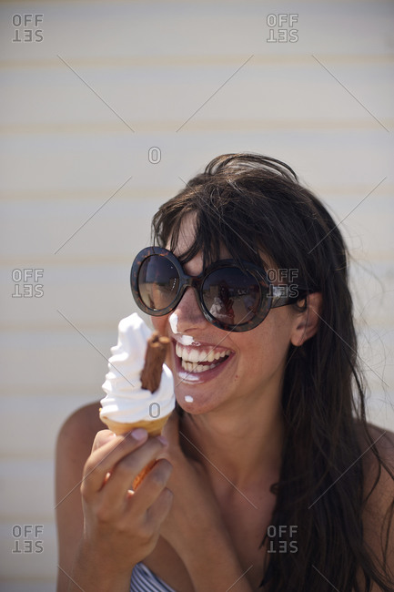 Smiling girl eating swirl ice cream