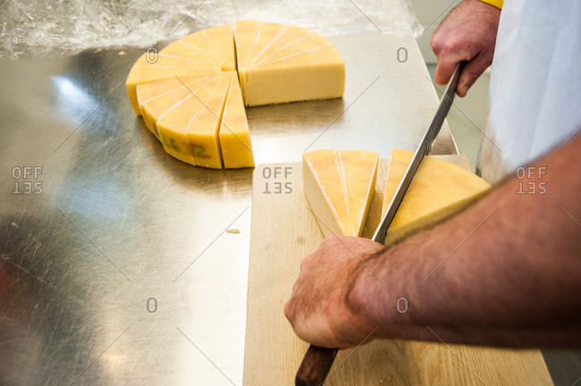 High angle view of man cutting cheese