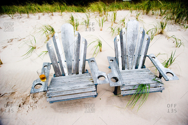 Wooden chairs on a sandy beach
