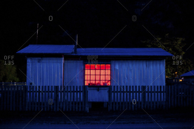 Exterior of a house at dusk in Villa O'Higgins, Chile