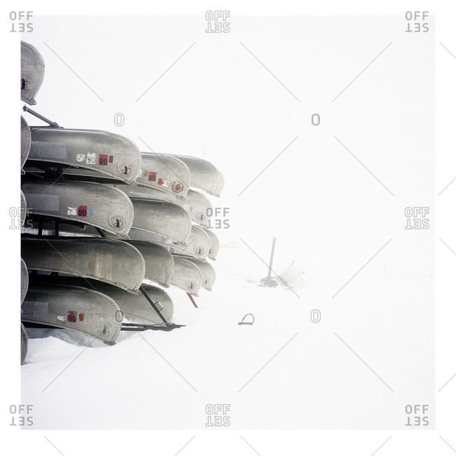 Stacked boats on snow - Offset