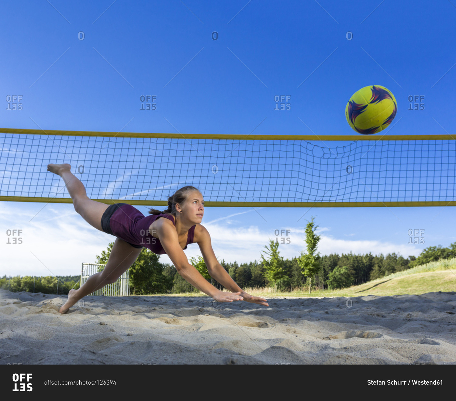 Young woman playing beach volleyball