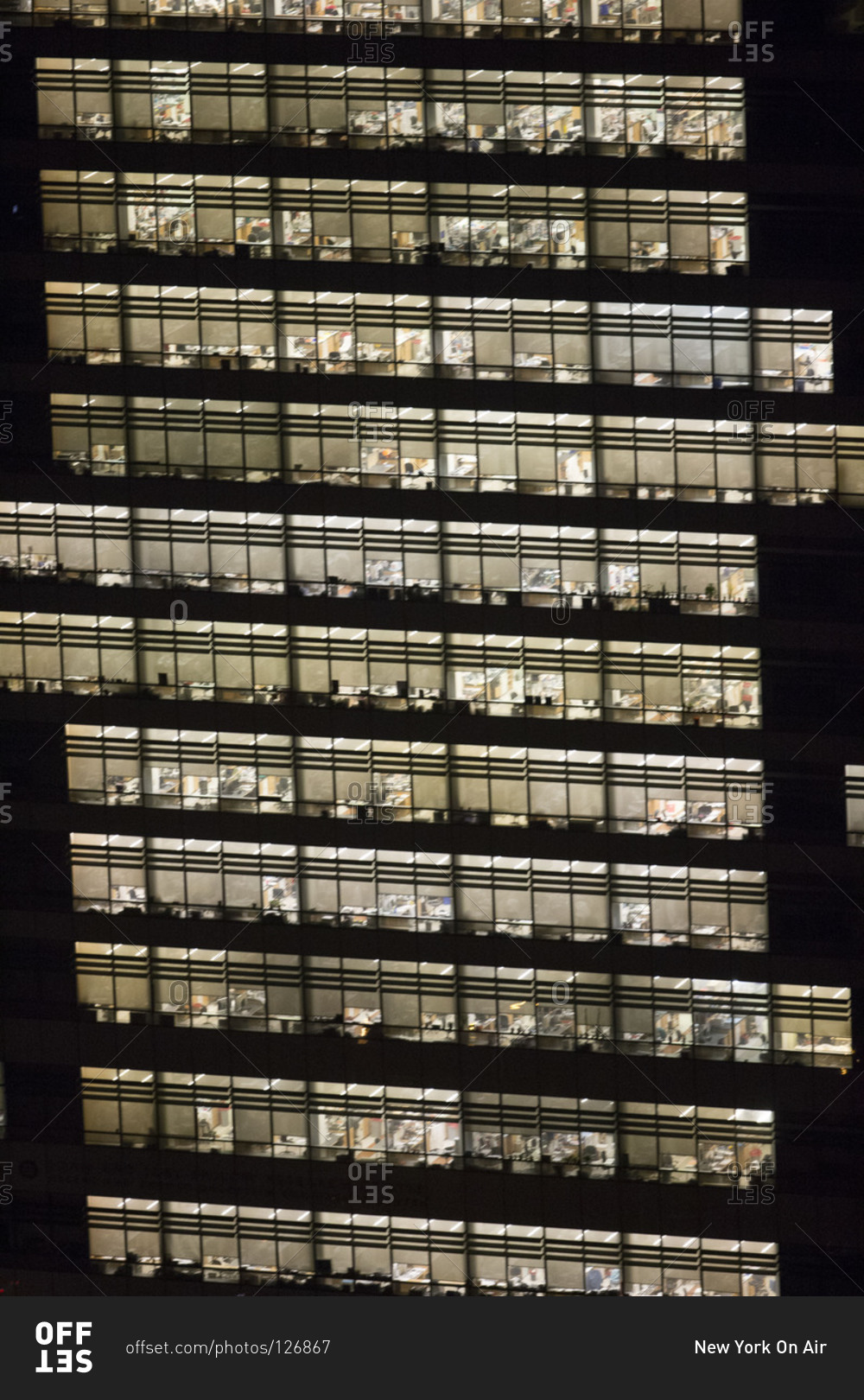 Illuminated office building at night in New York, USA