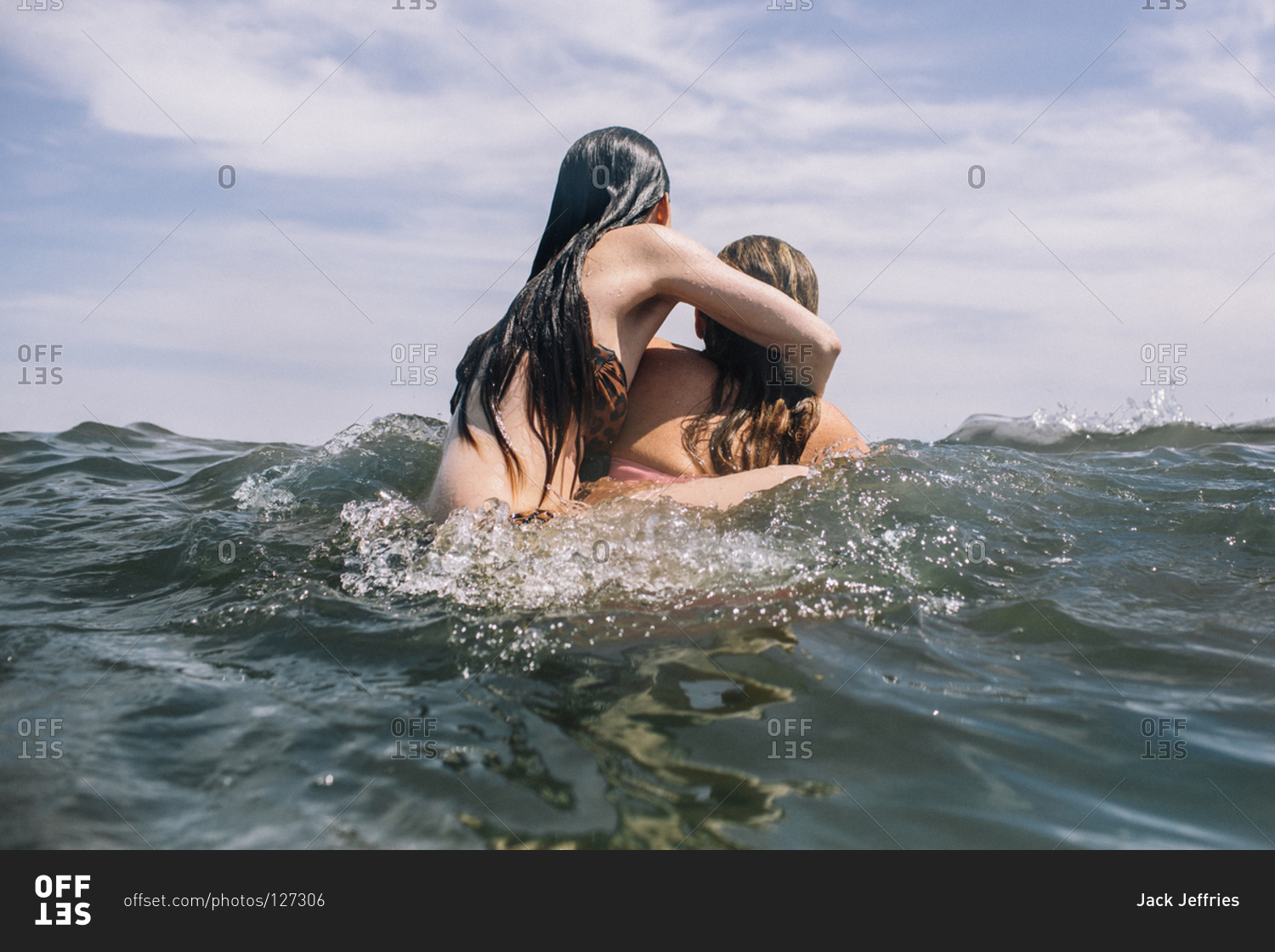 Young women wrestling in water