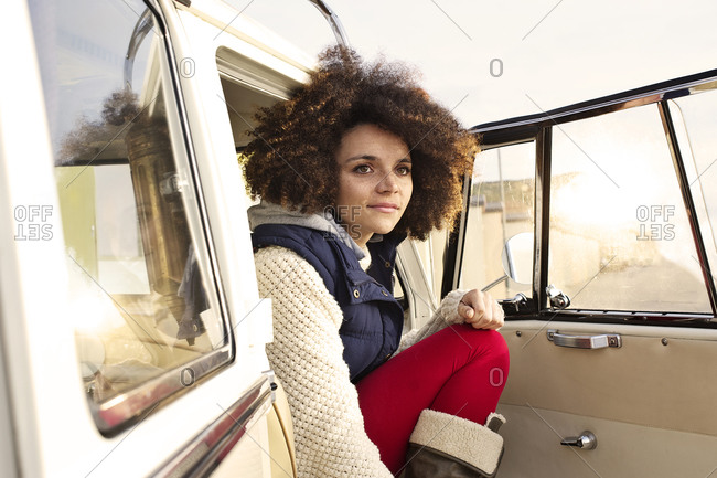 Girl sitting on a car's front passenger seat