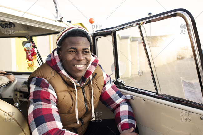 Smiling boy sitting in van on front seat