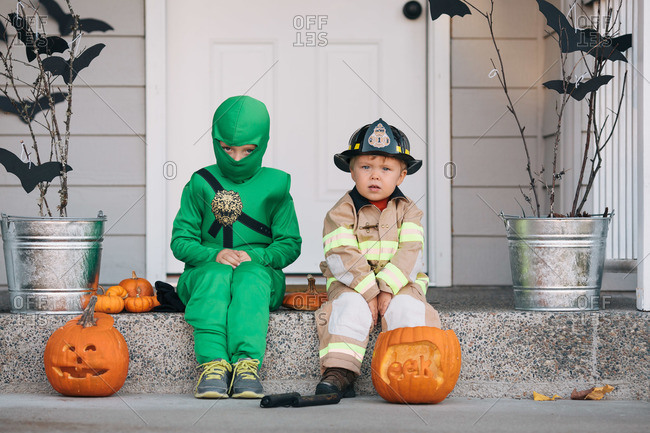 Children wearing ninja and firefighter costumes at Halloween