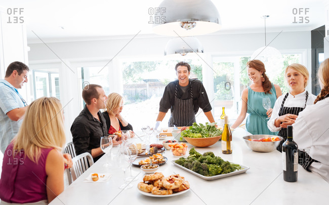 Personal Chef Around The Island In The Kitchen Having Fun Before The Meal Stock Photo Offset