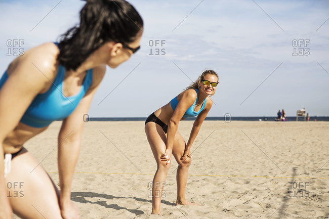 Beach volleyball players on a court