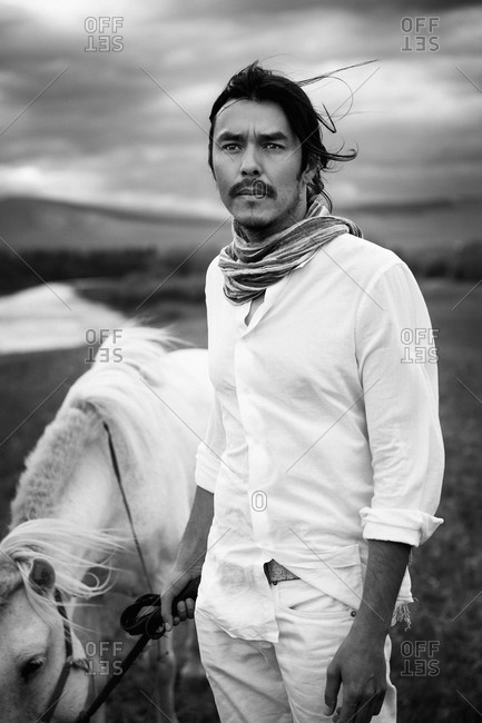 Mongolia - July 23, 2013: Rider and his horse on Mongolian steppe