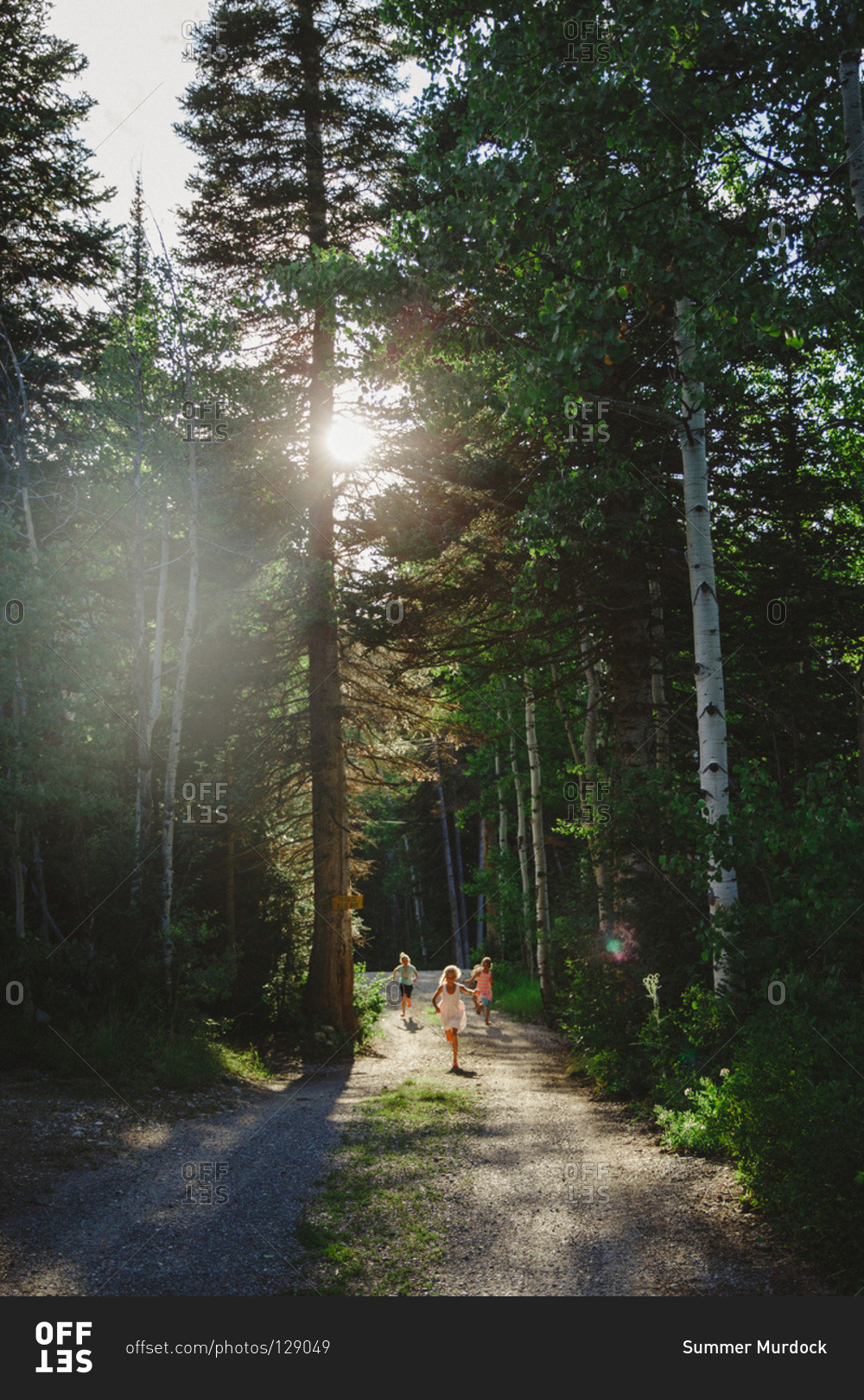Children running on forest path